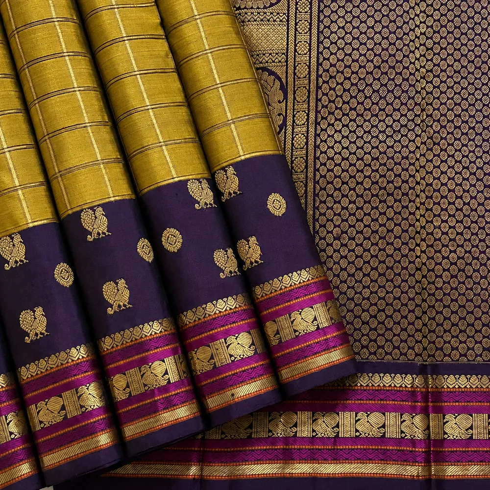 Close-up of a blue and orange Kanchipuram silk saree with intricate floral pallu