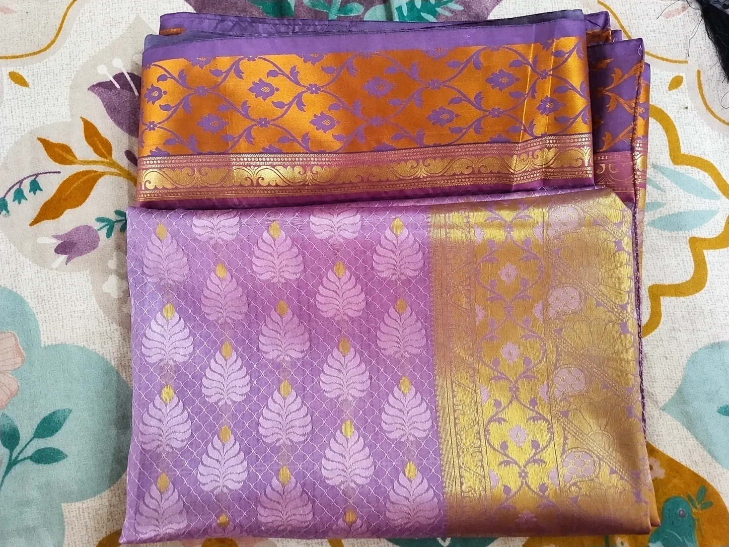 Old Kanchipuram silk saree buyers in Anna Nagar Chennai — folded purple and gold pattu saree