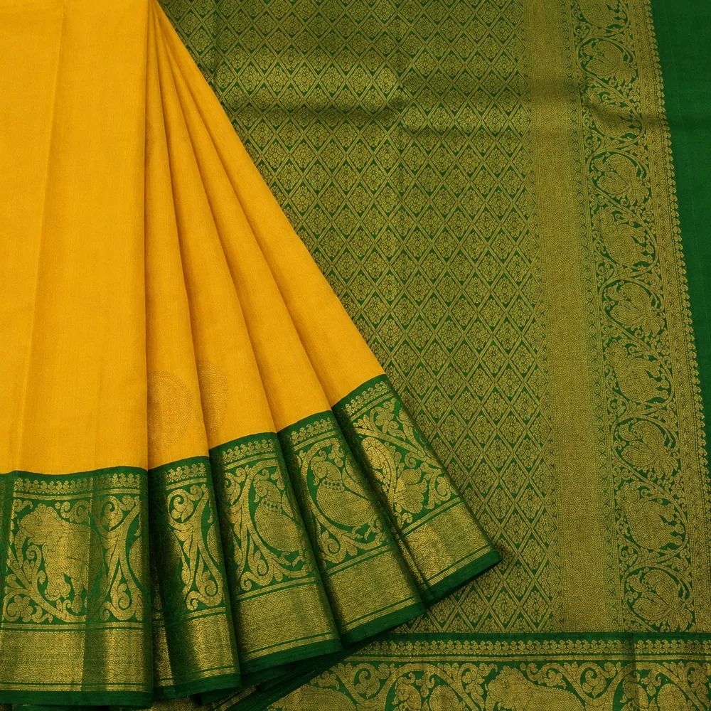 Folded silk sarees stacked with rich gold zari borders
